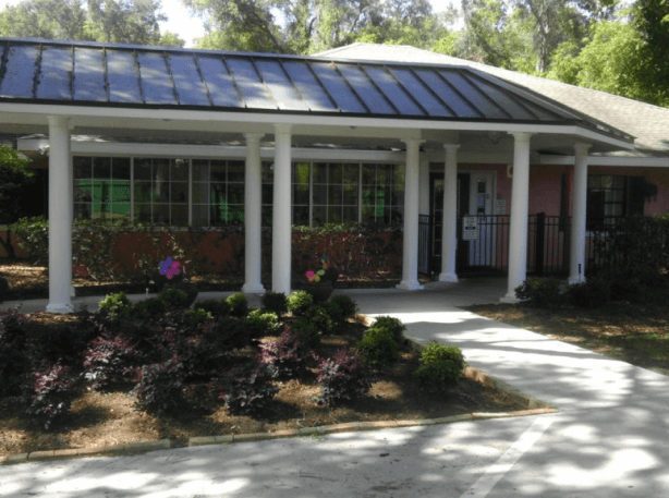 A pink building with a solar roof in Belleview.
