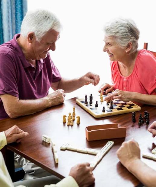 Elderly residents at an assisted living facility enjoy a game of chess together.